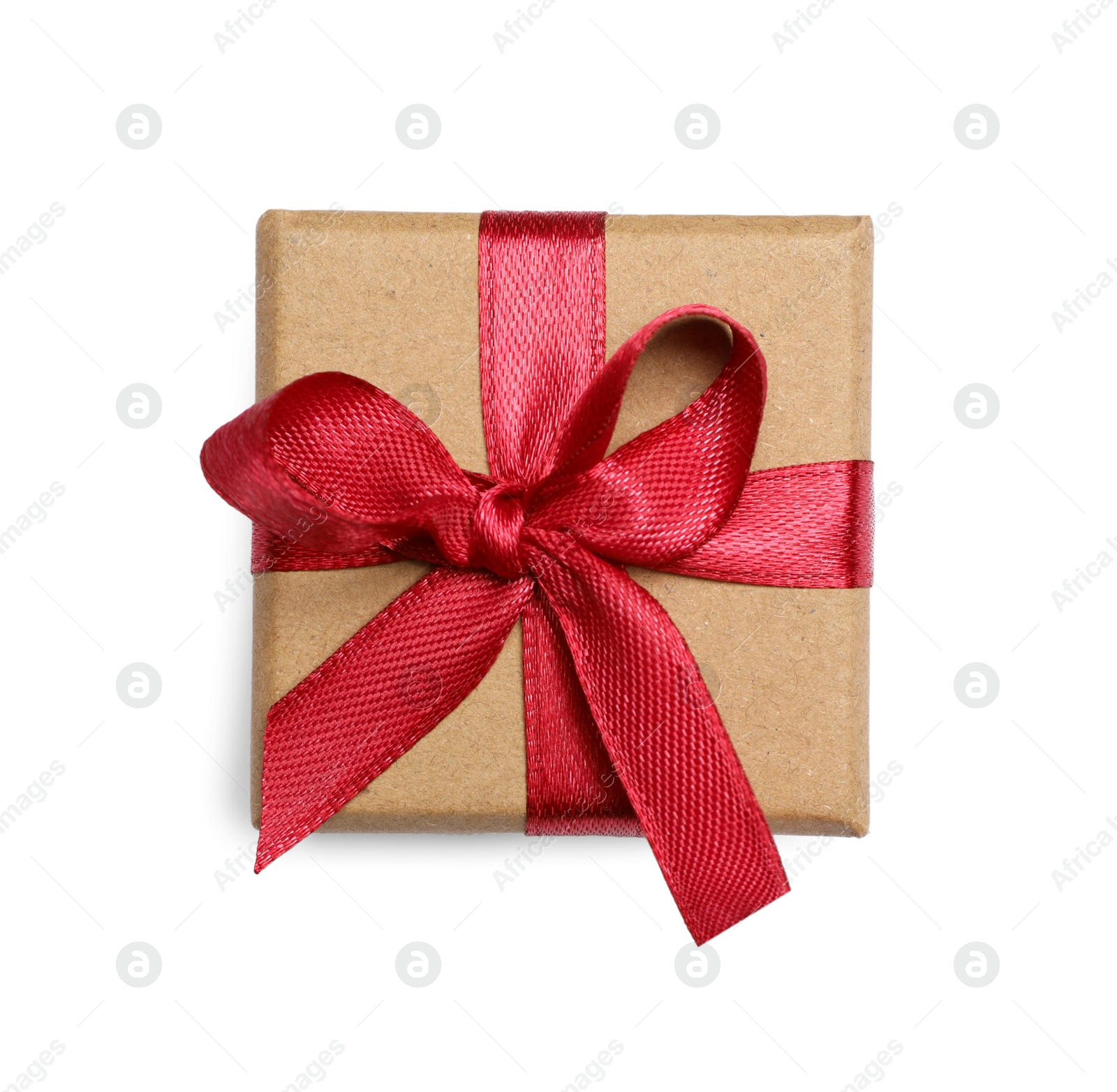 Photo of Christmas gift in kraft box with red ribbon isolated on white, top view