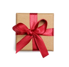 Photo of Christmas gift in kraft box with red ribbon isolated on white, top view