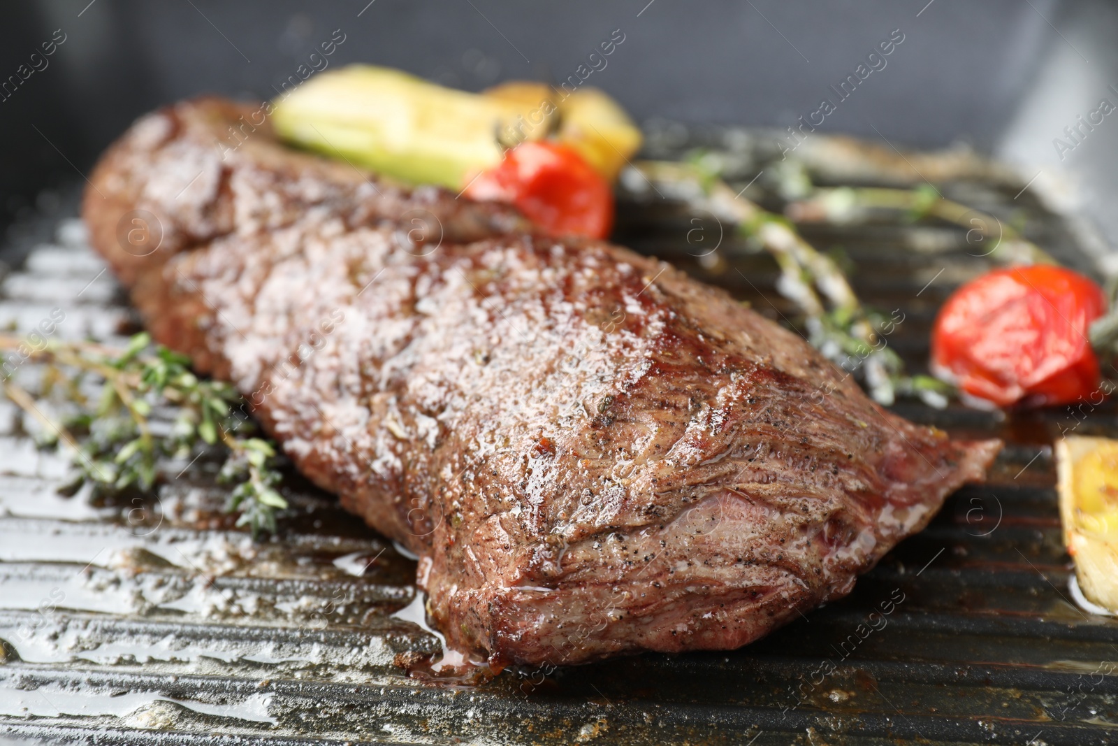 Photo of Delicious grilled beef meat and vegetables in pan, closeup