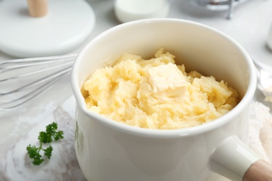 Photo of Saucepan with tasty mashed potato on table, closeup