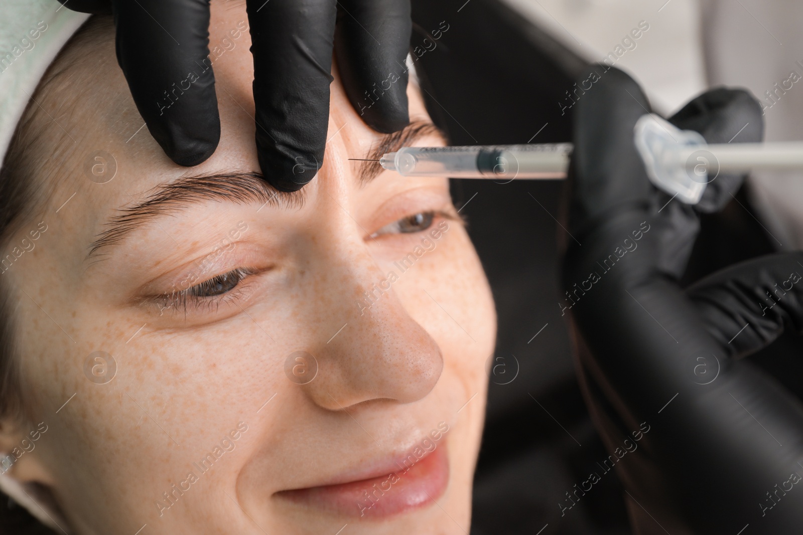 Photo of Cosmetologist giving facial injection to patient, closeup. Cosmetic surgery