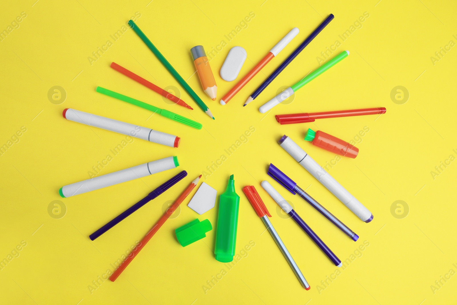 Photo of Frame of different school stationery on yellow background, flat lay with space for text. Back to school