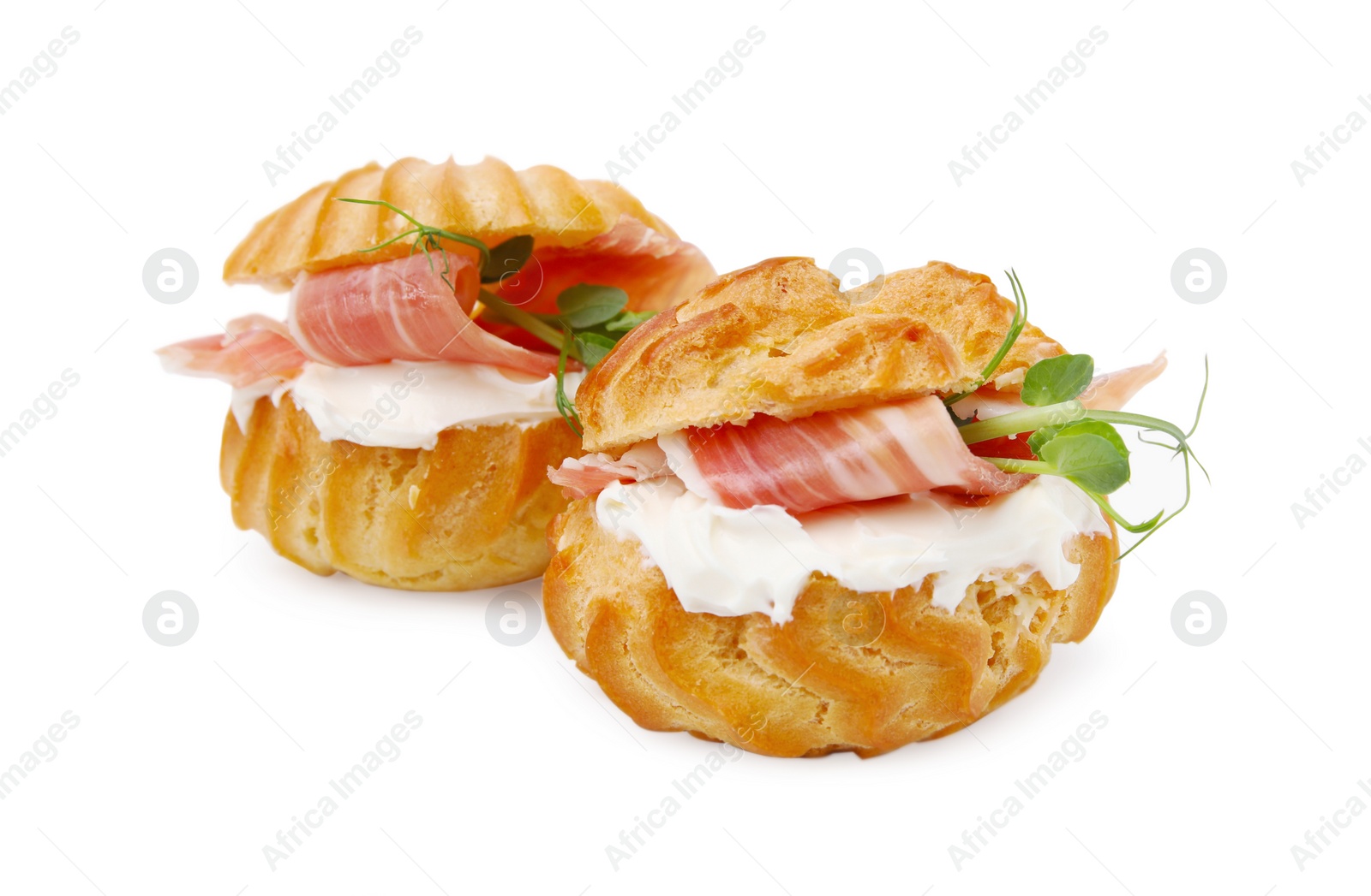 Photo of Delicious profiteroles with cream cheese and prosciutto isolated on white