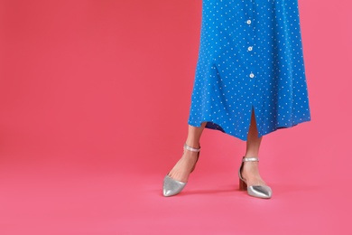 Photo of Woman in stylish shoes on pink background. Space for text