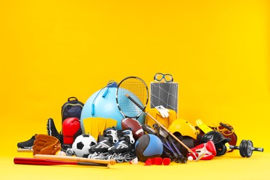 Photo of Many different sports equipment on yellow background, space for text