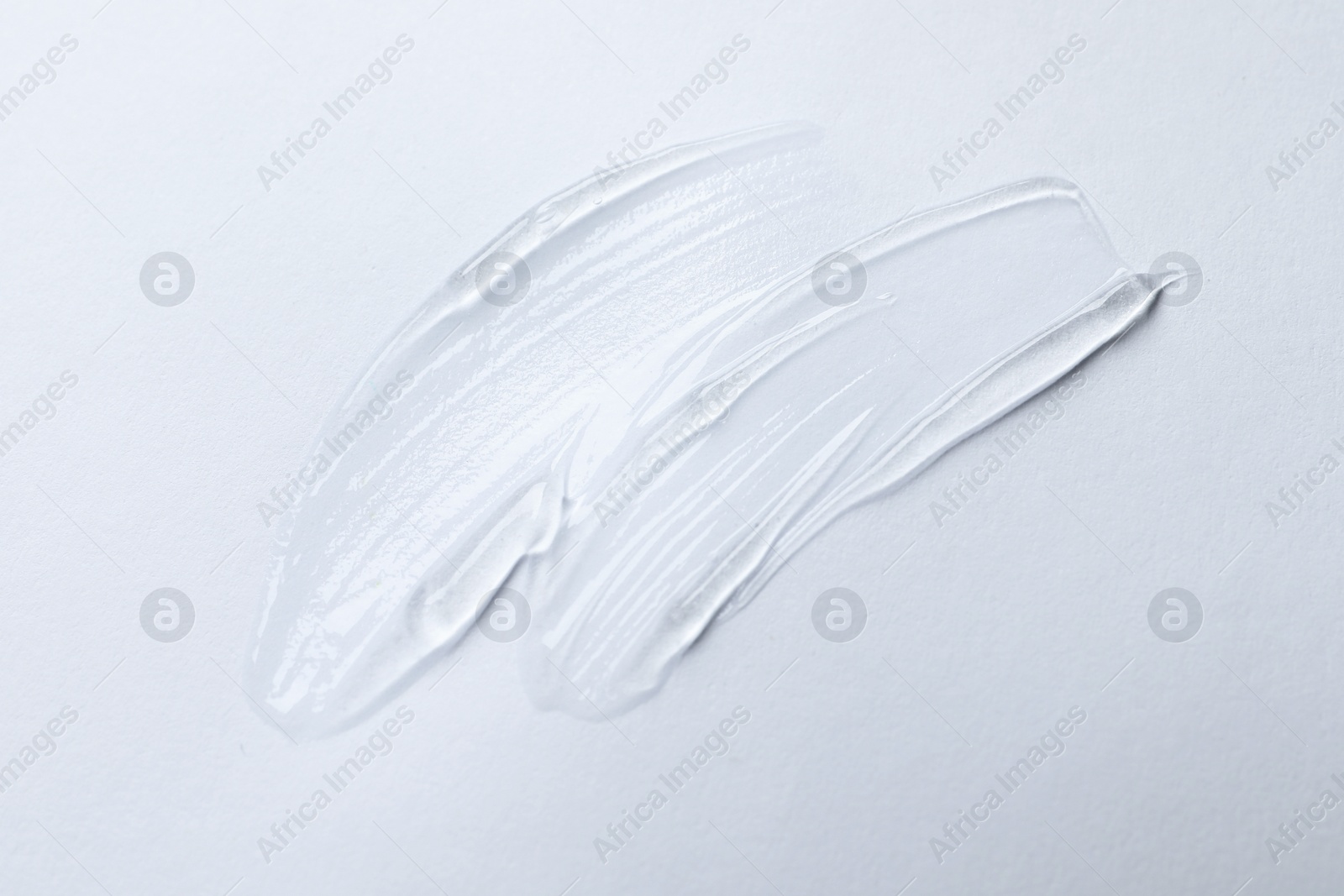 Photo of Swatches of cosmetic gel on white background, top view
