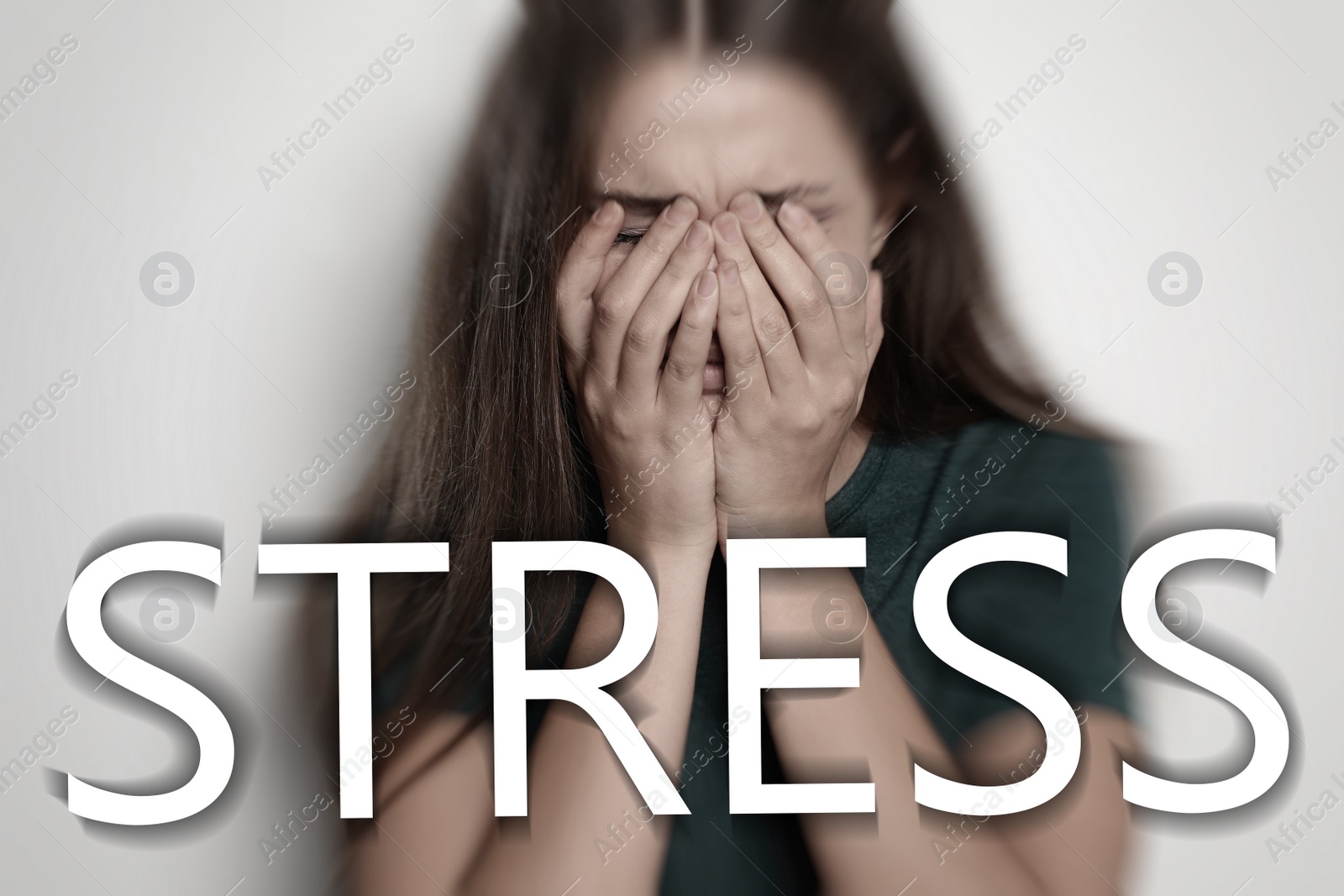 Image of Word STRESS and depressed young woman crying on light background 