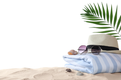 Composition with beach objects on sand against white background, space for text