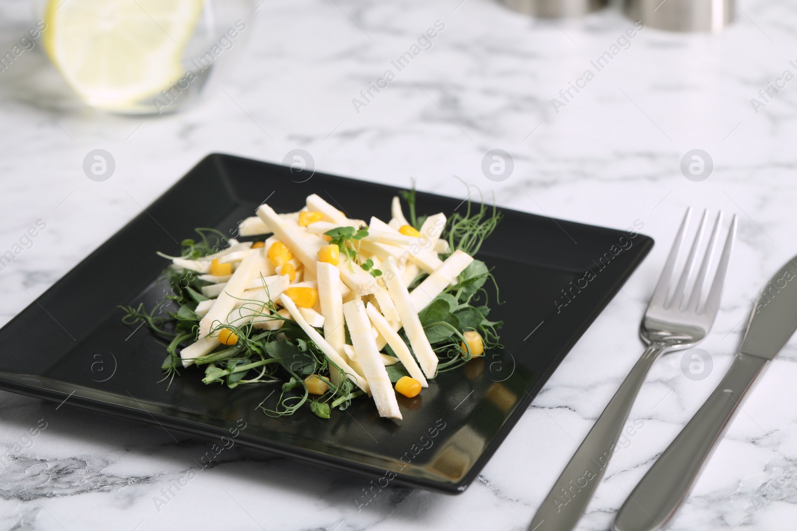 Photo of Delicious carrot salad served on white marble table, closeup