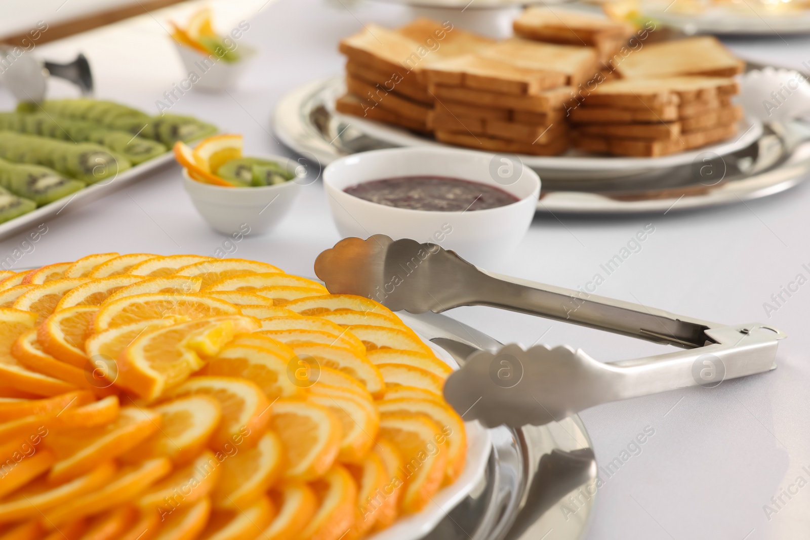 Photo of Different meals for breakfast on white table indoors. Buffet service