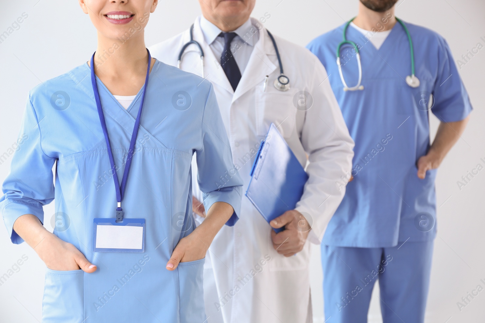 Photo of Doctors against light background, closeup. Medical service