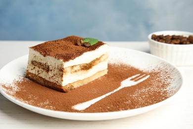 Photo of Plate of tiramisu cake on white table