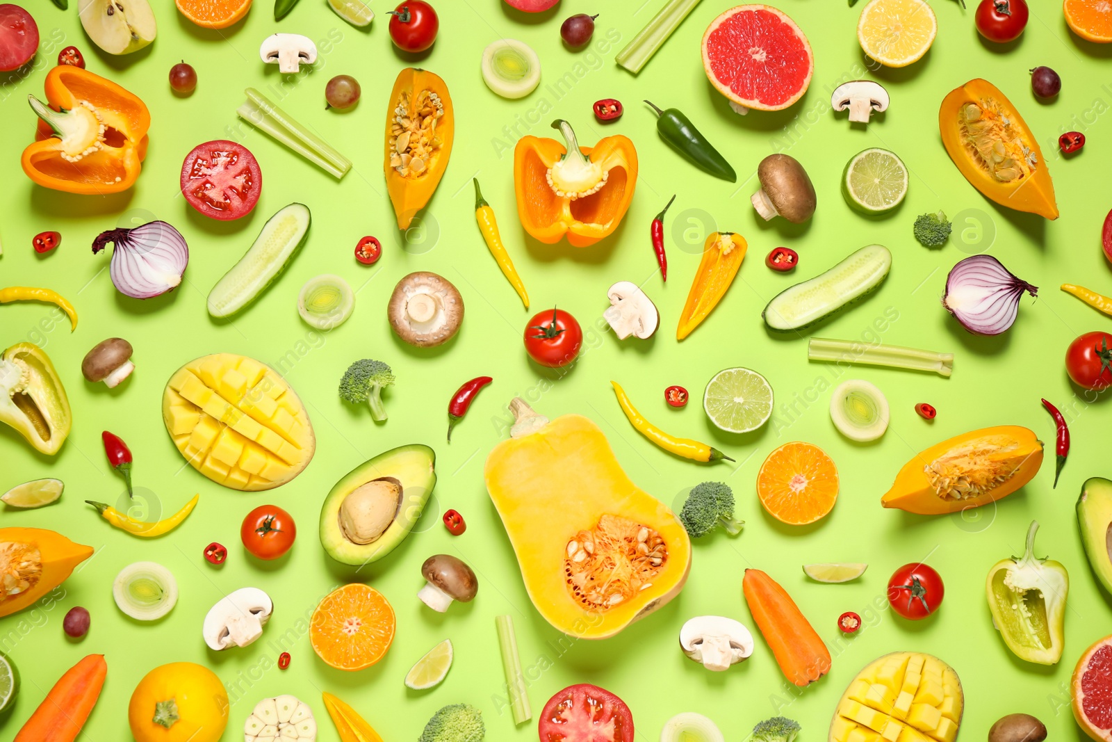 Photo of Flat lay composition with fresh organic fruits and vegetables on light green background