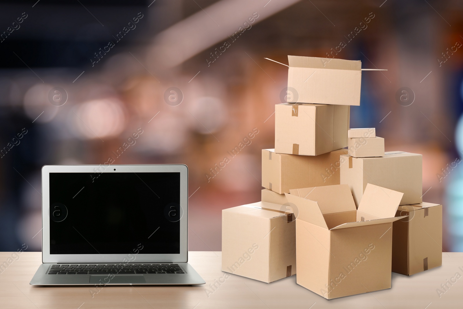 Image of Online selling. Laptop and parcels on table in store