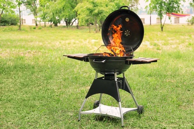 Modern barbecue grill with fire flames outdoors