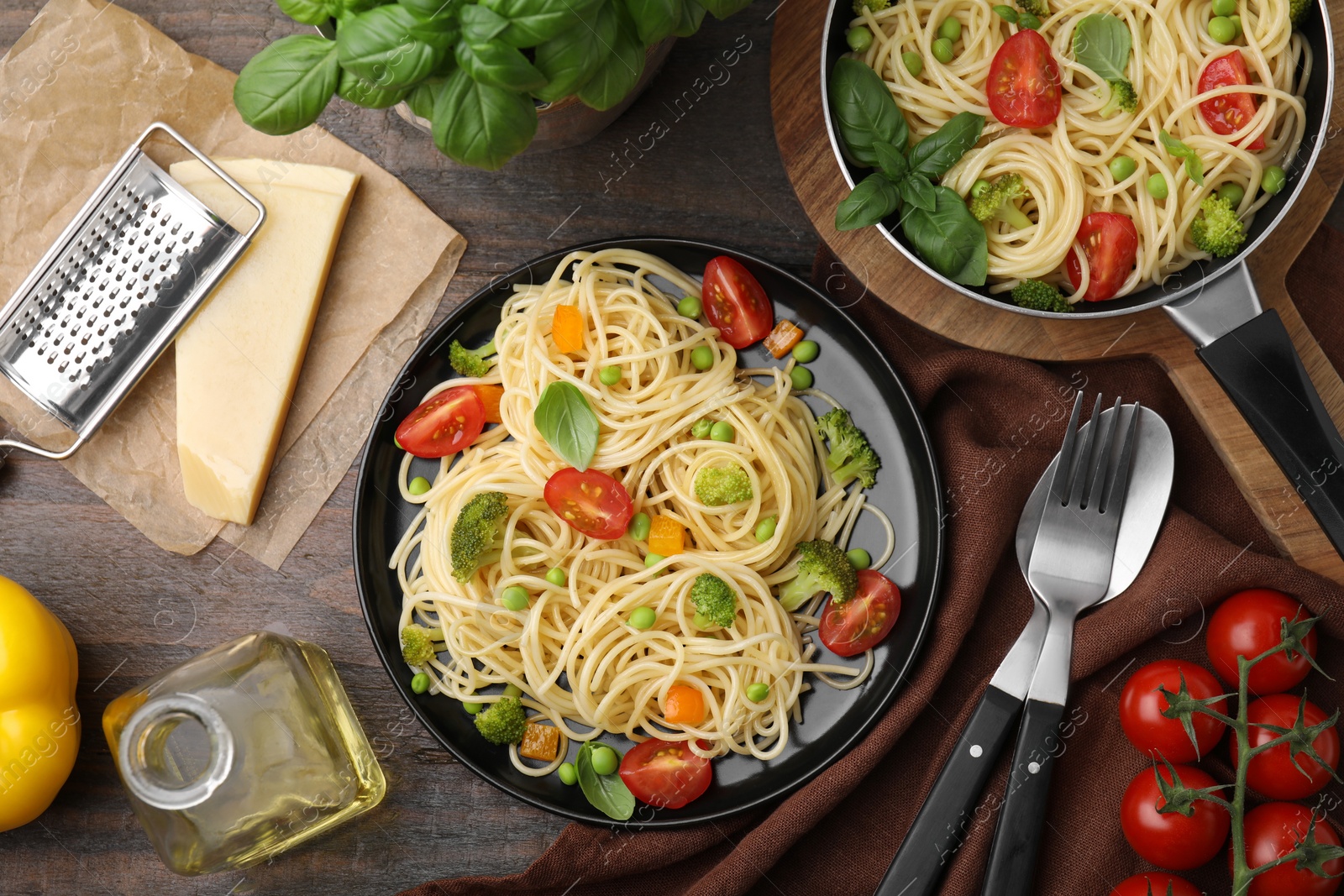 Photo of Flat lay composition with delicious pasta primavera on wooden table