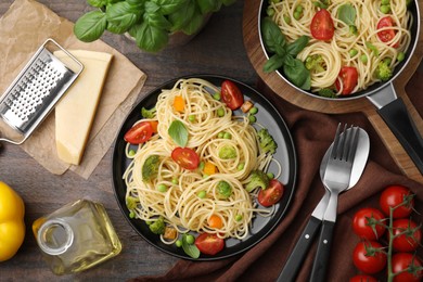 Flat lay composition with delicious pasta primavera on wooden table
