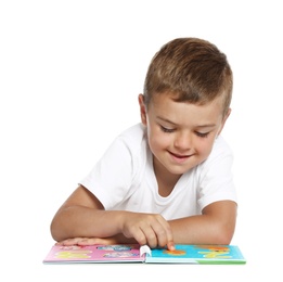 Cute little boy reading book on white background