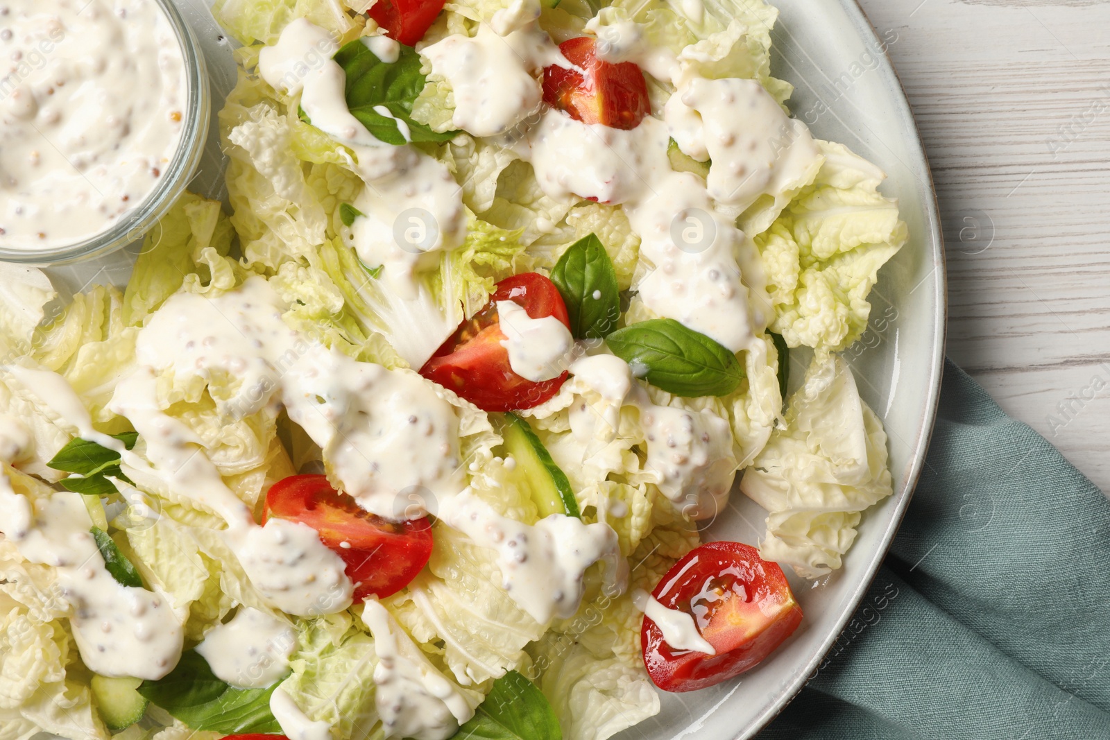 Photo of Delicious salad with Chinese cabbage, tomatoes, cucumber and dressing on white wooden table, top view