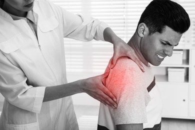 Doctor examining man with shoulder pain in hospital