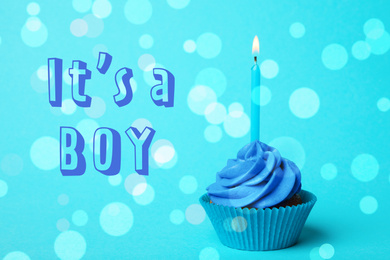 Image of Baby shower cupcake with candle for boy on light blue background