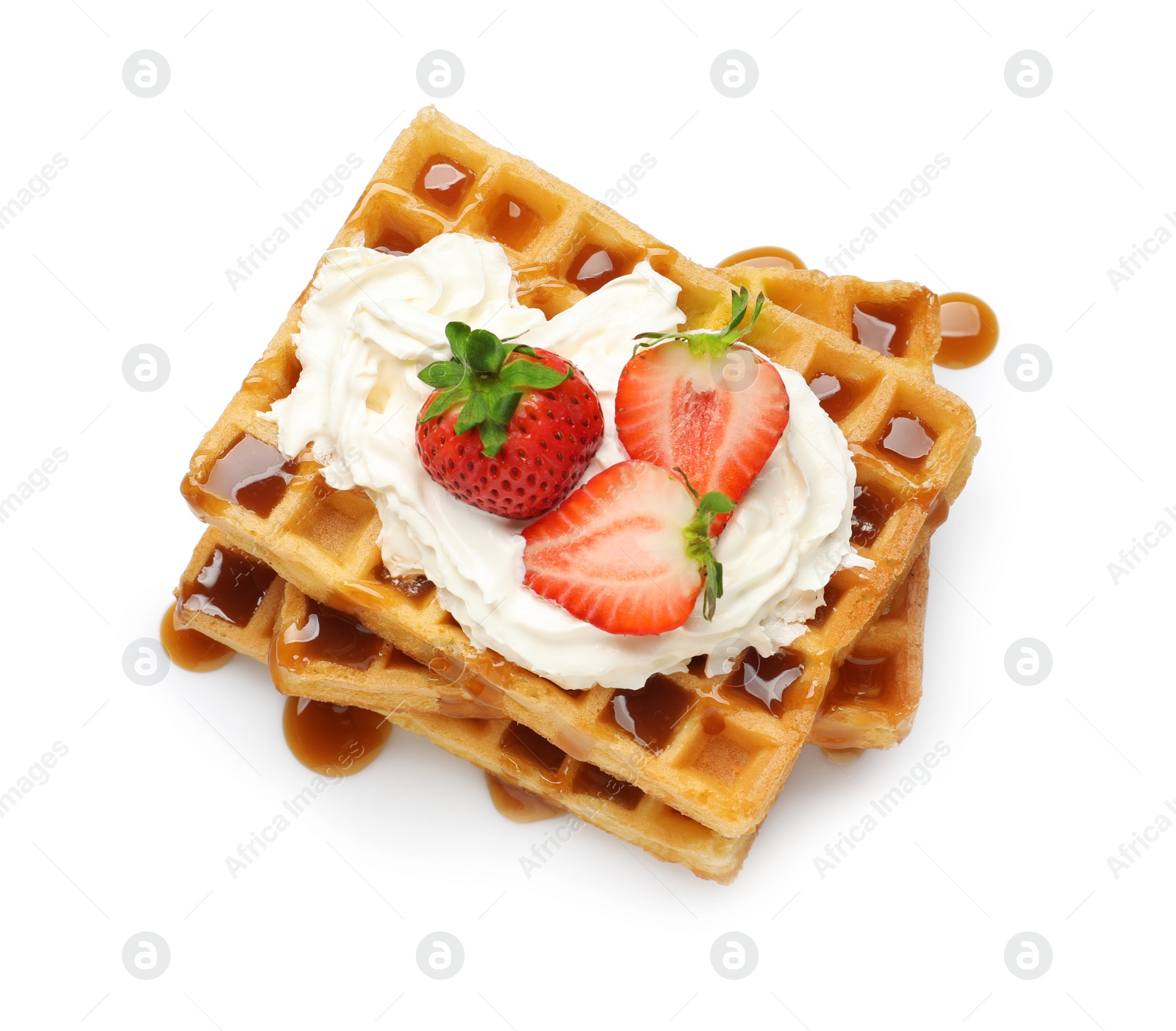 Photo of Yummy waffles with whipped cream, strawberries and caramel syrup on white background, top view