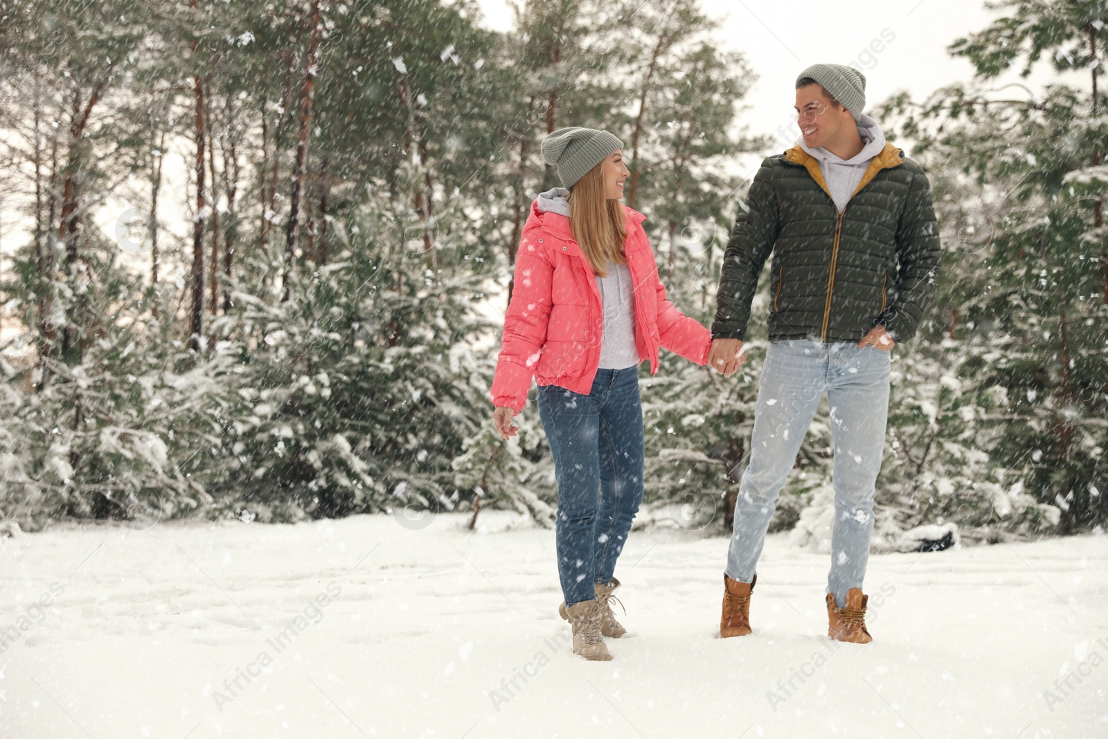 Photo of Beautiful happy couple in snowy forest on winter day