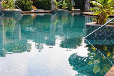 Photo of Outdoor swimming pool with clear water at luxury resort