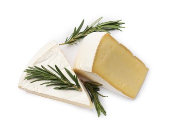 Photo of Pieces of tasty camembert cheese and rosemary isolated on white, top view