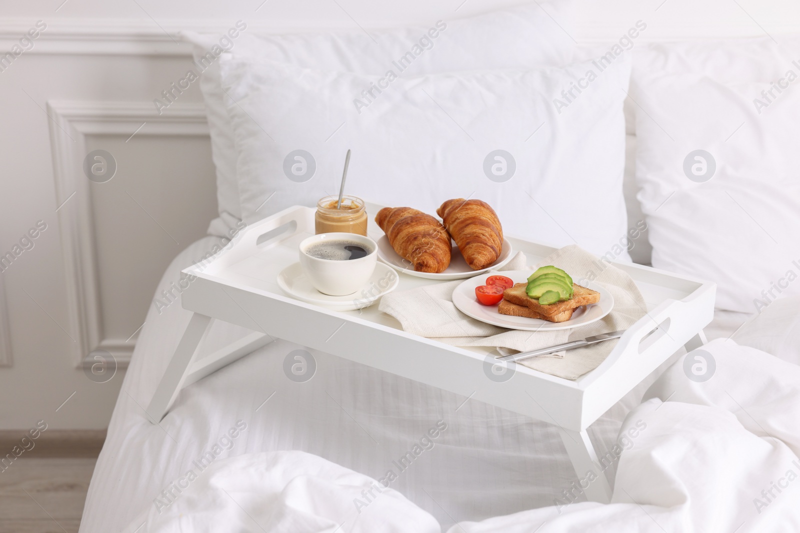 Good morning. Tray with tasty breakfast on bed at home Photo of Good morning. Tray with tasty breakfast on bed at home