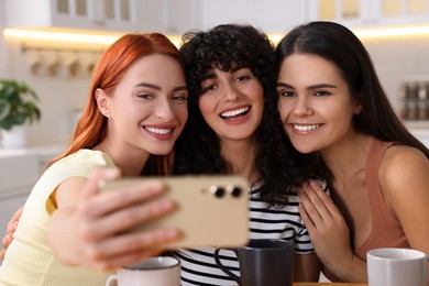 Photo of Happy young friends taking selfie at home