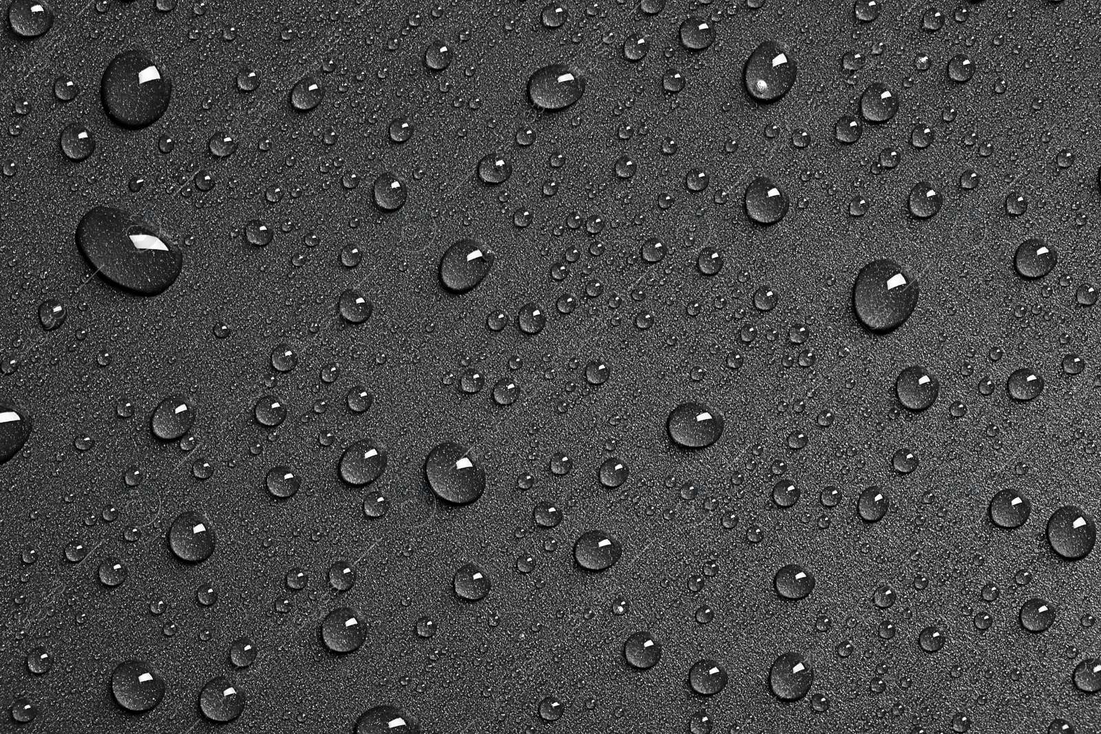 Photo of Water drops on black background, top view