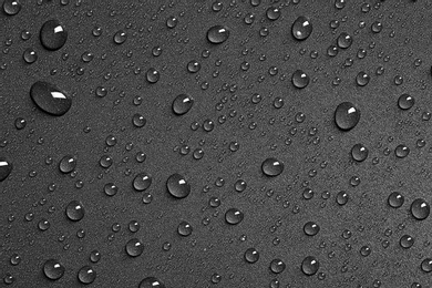 Photo of Water drops on black background, top view