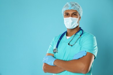 Photo of Doctor or medical assistant (male nurse) with protective mask and stethoscope on turquoise background. Space for text