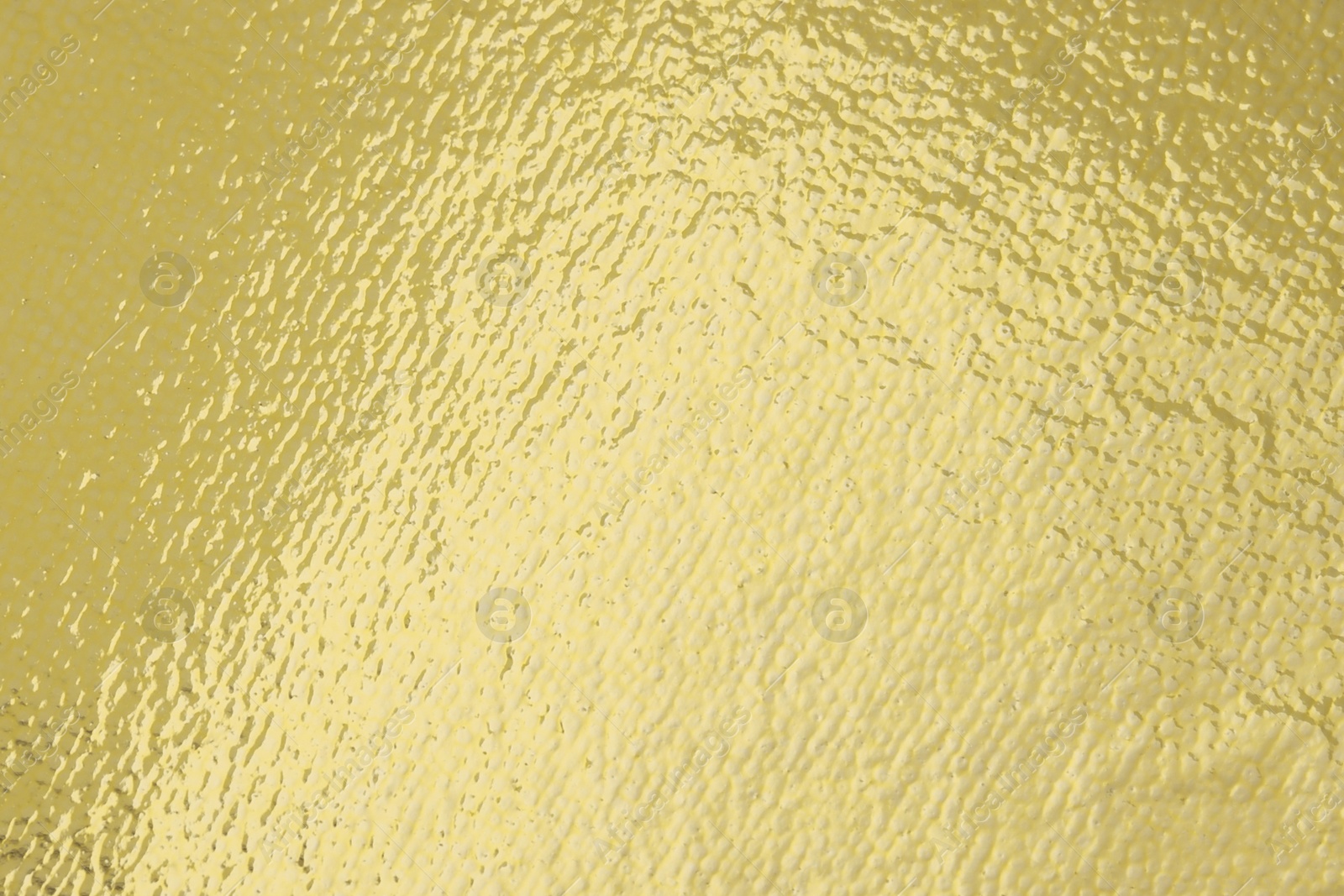 Photo of Edible gold leaf sheet as background, closeup