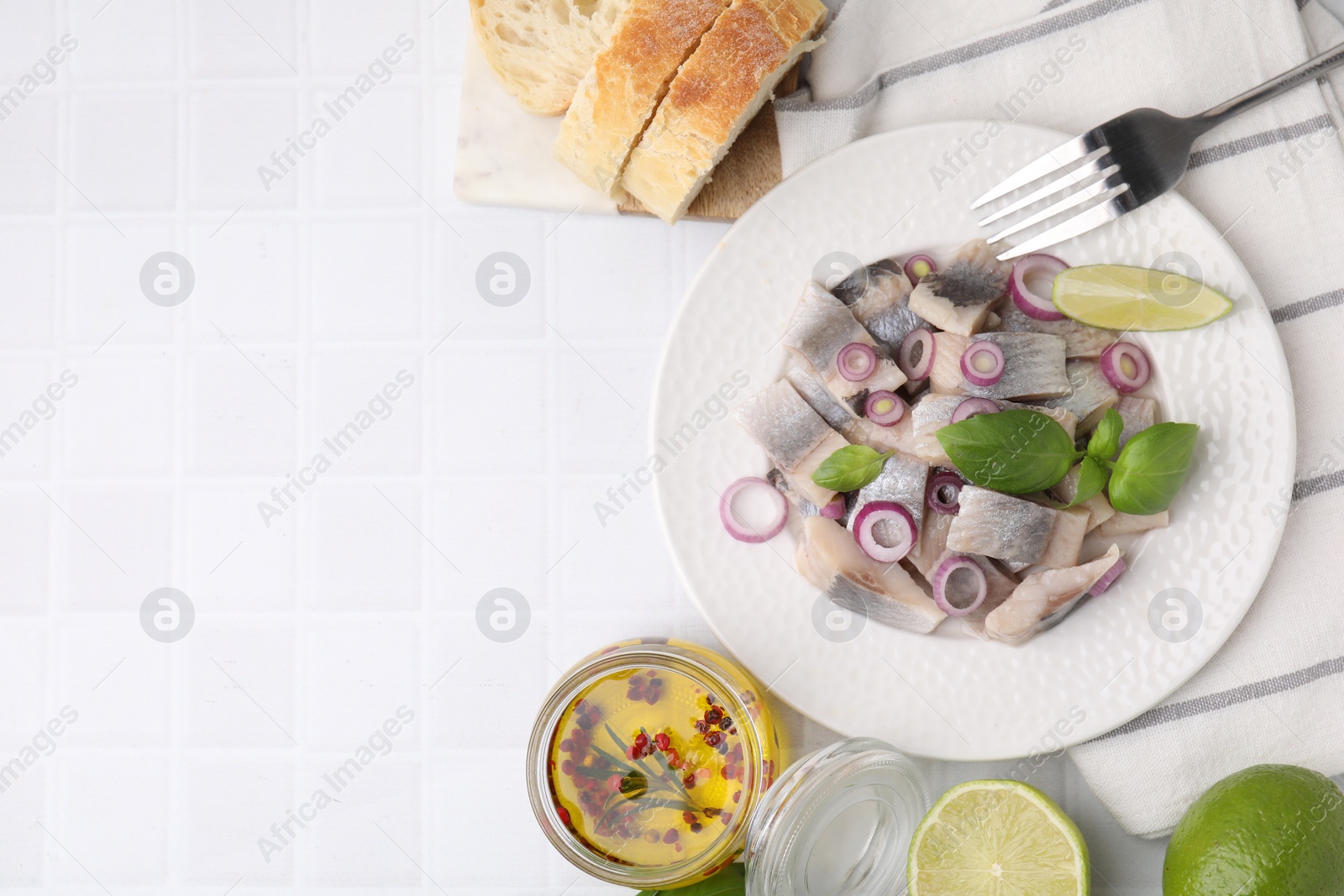 Photo of Plate with tasty fish and marinade on light tiled table, flat lay. Space for text