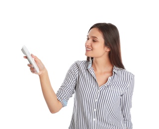 Photo of Happy young woman operating air conditioner with remote control on white background