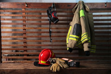 Photo of Firefighter`s uniform, helmet, gloves and mask at station