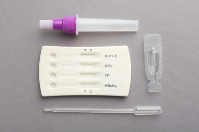 Photo of Disposable multi-infection express test kit on grey background, flat lay