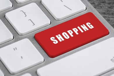 Image of Online store purchase. Red button with word Shopping on computer keyboard, closeup