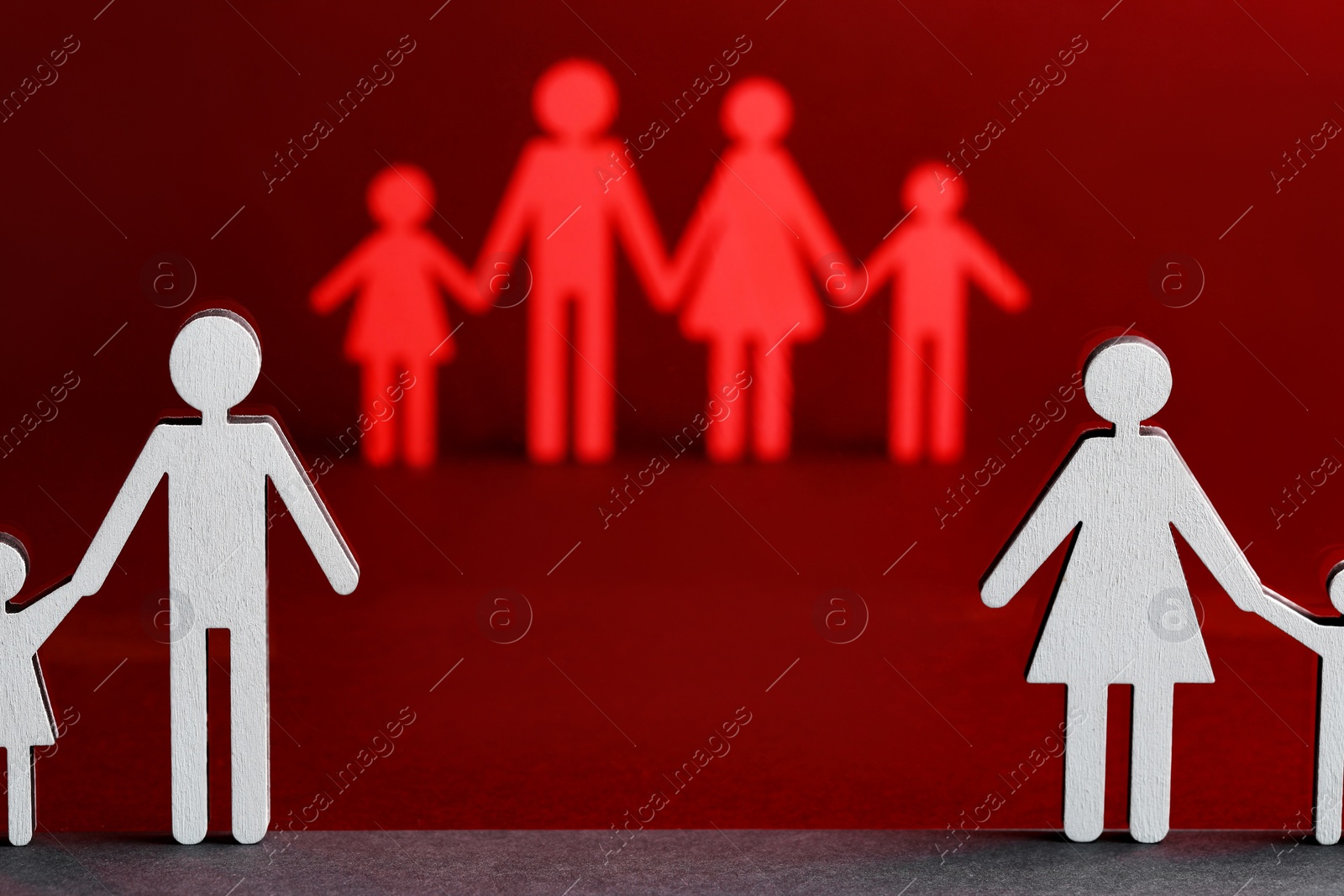 Photo of Paper figures of married and divorced family on color background