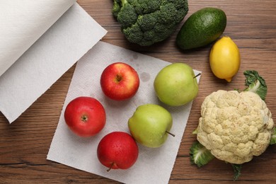 Photo of Apples drying on paper towel, fruits and vegetables on wooden table, flat lay