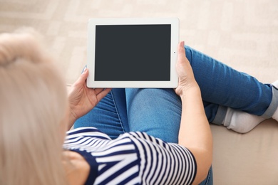 Photo of Woman using video chat on tablet at home. Space for text