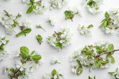 Photo of Flat lay composition of beautiful fresh spring flowers on wooden background