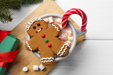 Photo of Tasty homemade Christmas cookie and hot chocolate with marshmallows on white wooden table, top view. Space for text