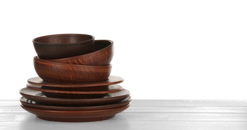 Different clay dishware on white wooden table