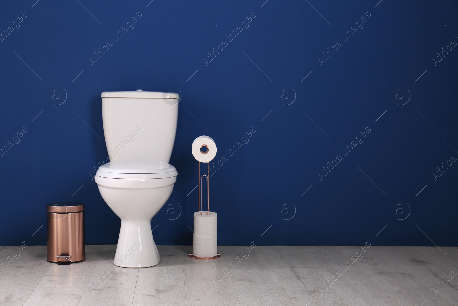 Photo of Simple bathroom interior with new toilet bowl near color wall. Space for text