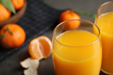 Glass of fresh tangerine juice, closeup view