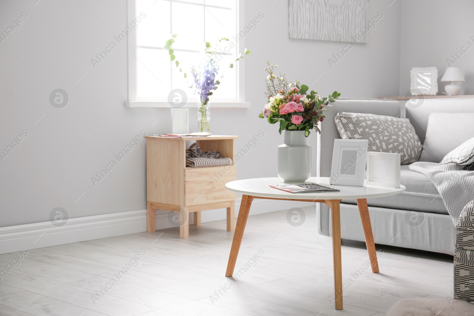 Photo of Cozy living room interior with comfortable sofa and elegant table