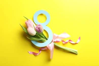 Photo of 8 March card design with tulips on yellow background, flat lay. International Women's Day